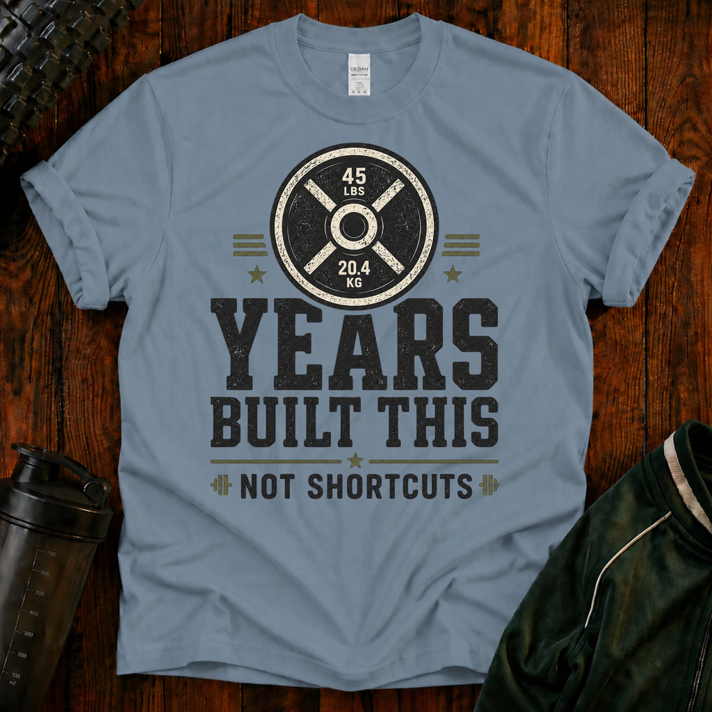 Fitness T-Shirt — “Years Built This, Not Shortcuts” Weightlifting Plate Tee