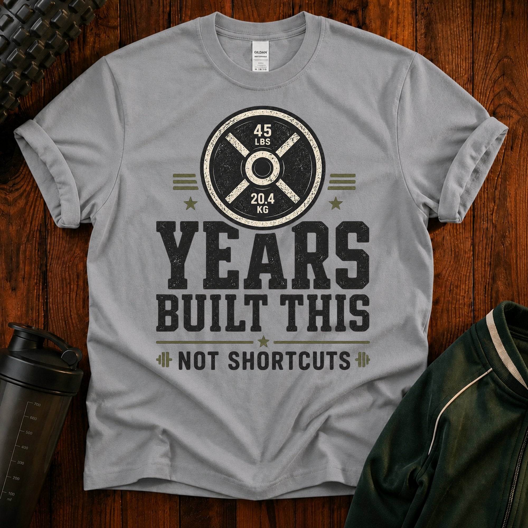 Fitness T-Shirt — “Years Built This, Not Shortcuts” Weightlifting Plate Tee