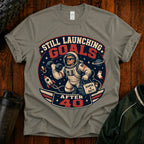 T-Shirt — "Still Launching Goals After 40" Astronaut Graphic Tee