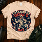 T-Shirt — "Still Launching Goals After 40" Astronaut Graphic Tee