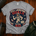 T-Shirt — "Still Launching Goals After 40" Astronaut Graphic Tee